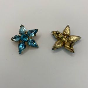 2 Vintage Coro rhinestone brooches. Pale blue in gold tone setting.